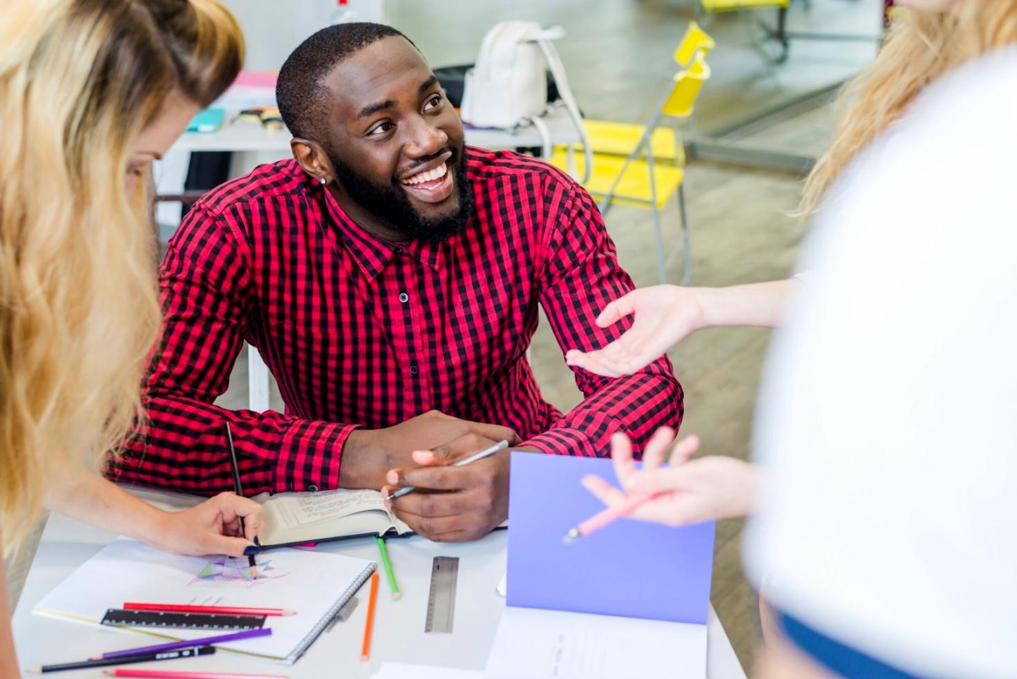 Students analyzing financial data on computer screens in modern classroom setting